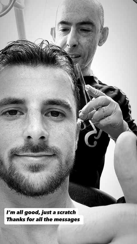 a black and white photo of a man getting his hair cut