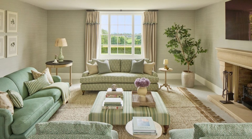 a living room with green furniture and a fireplace