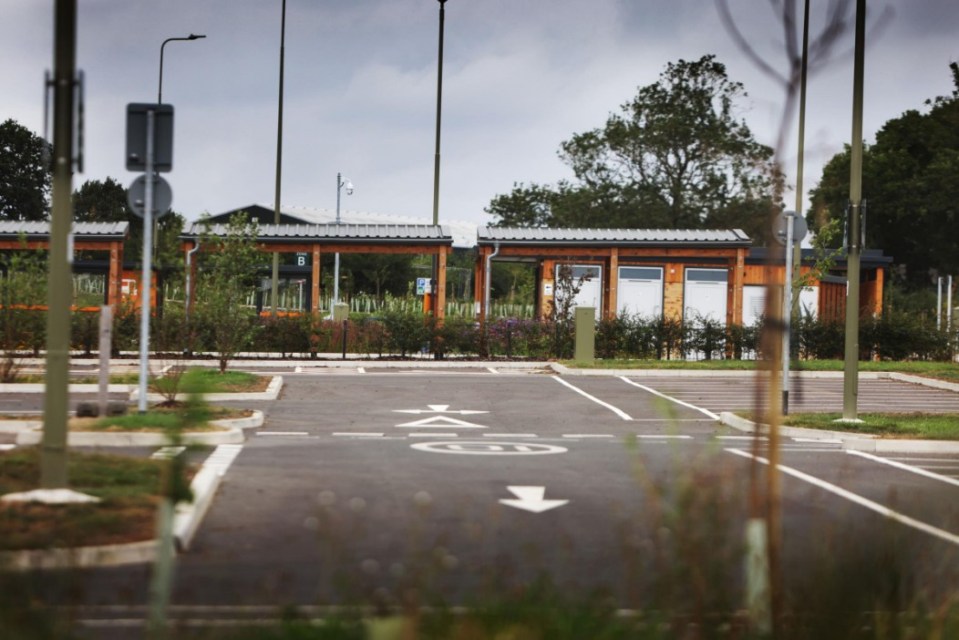 The park and ride in Eynsham. Photo released September 2 2024. Surreal pictures show a multi-million-pound park and ride which has no access road lying empty. All major construction work at the 19-acre park and ride on the A40 eastbound in Eynsham was completed in January.But there will be no vehicles parking in the 850 spaces at the £51million facility until the funding is secured for the infrastructure to connect it to the A40.The permanent landscaping was completed earlier this month, and the county council is now providing ongoing maintenance of the site as part of the current contract...