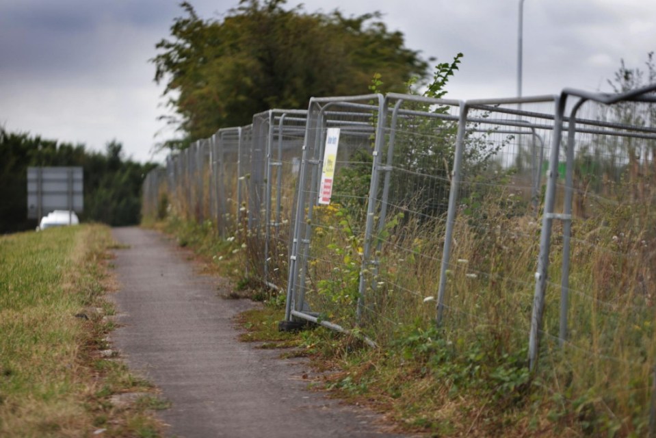 The park and ride in Eynsham. Photo released September 2 2024. Surreal pictures show a multi-million-pound park and ride which has no access road lying empty. All major construction work at the 19-acre park and ride on the A40 eastbound in Eynsham was completed in January.But there will be no vehicles parking in the 850 spaces at the £51million facility until the funding is secured for the infrastructure to connect it to the A40.The permanent landscaping was completed earlier this month, and the county council is now providing ongoing maintenance of the site as part of the current contract...