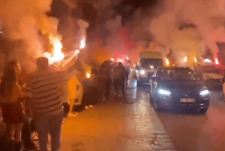 Fans lined the streets with flares to welcome his car