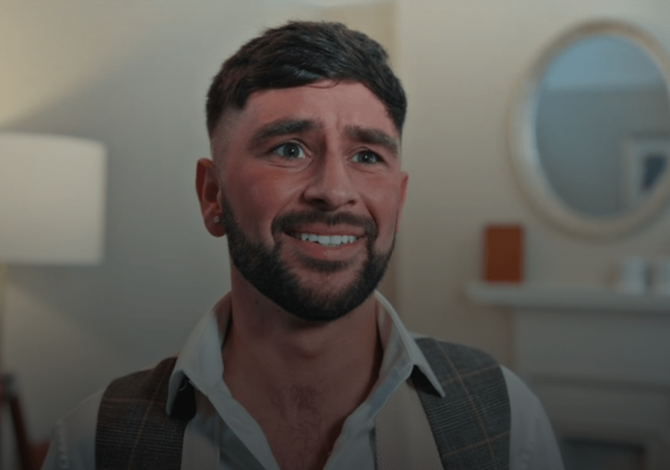 a man with a beard is smiling in front of a mirror