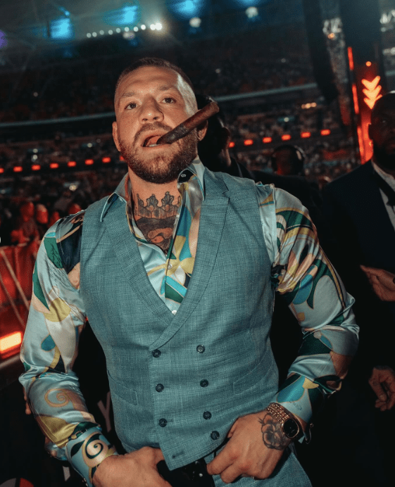 Conor McGregor with an unlit cigar at Anthony Joshua’s fight