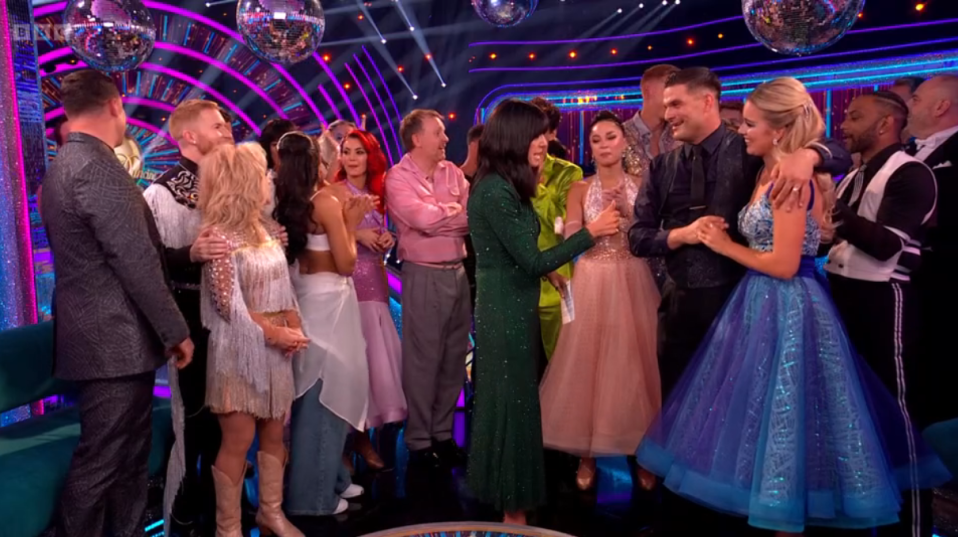 a group of people standing in a room with bbc written on the bottom