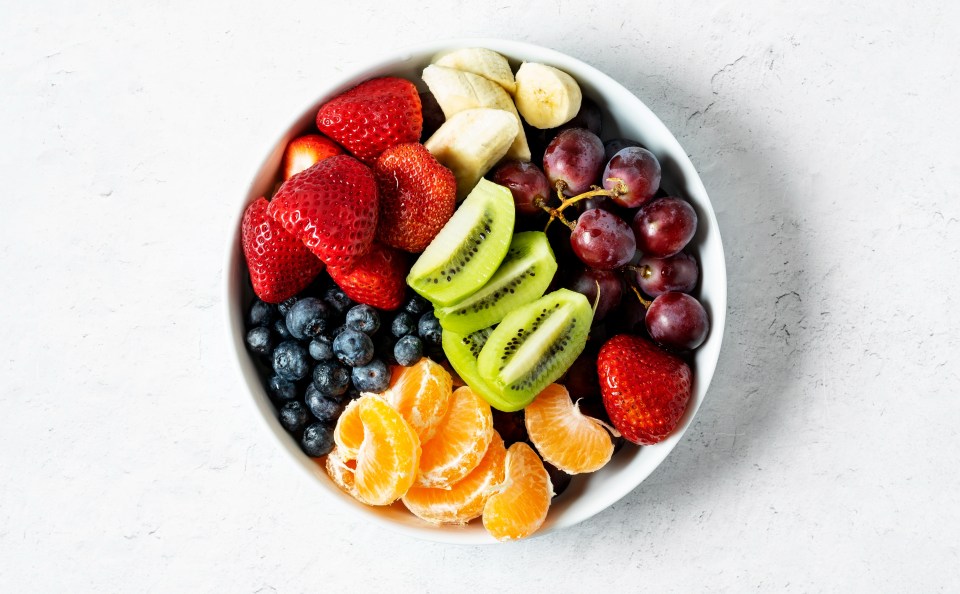 a white bowl filled with different types of fruit