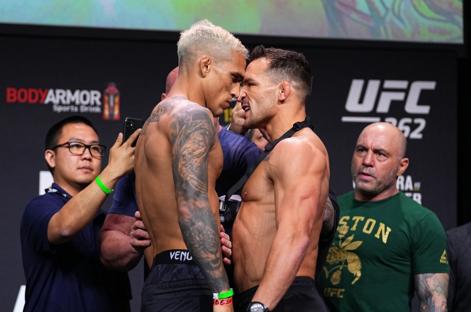 two men standing next to each other in front of a sign that says ufc