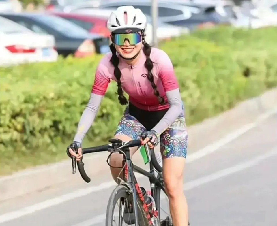 a woman wearing a helmet and goggles is riding a bike