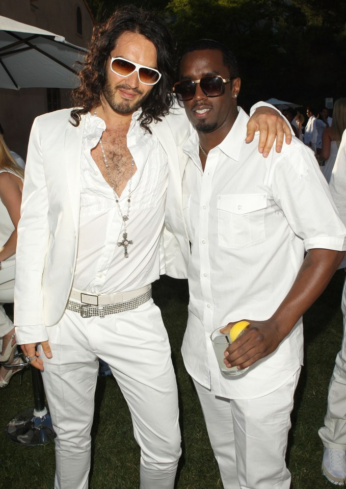 two men wearing all white pose for a picture