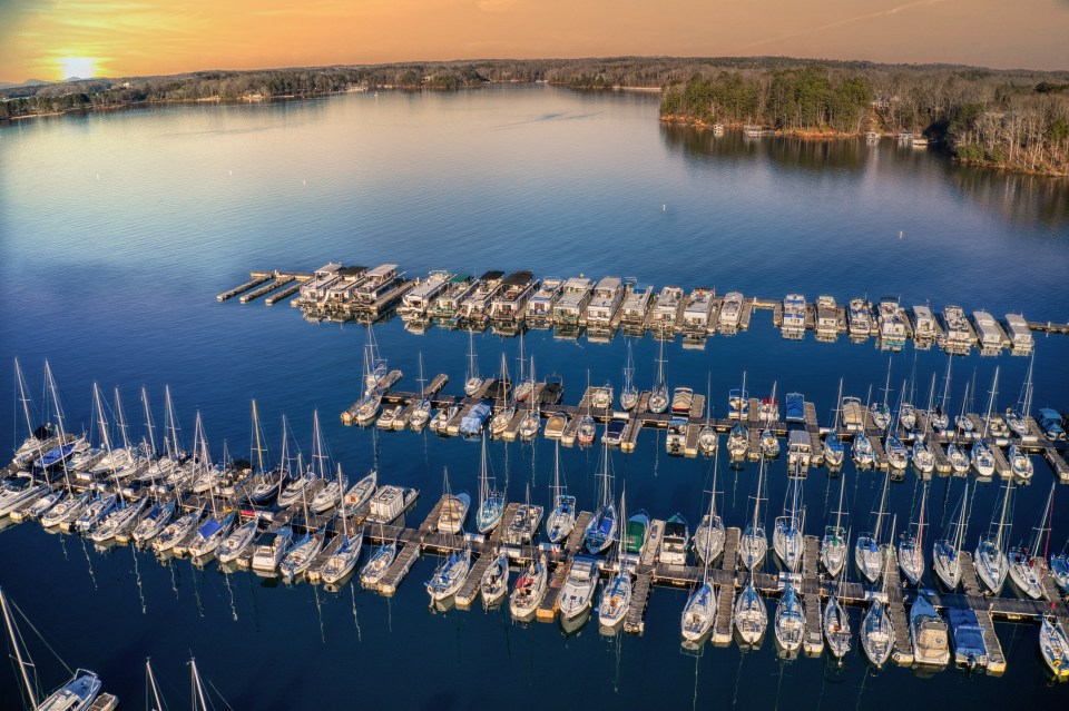 an aerial view of a marina with many boats docked