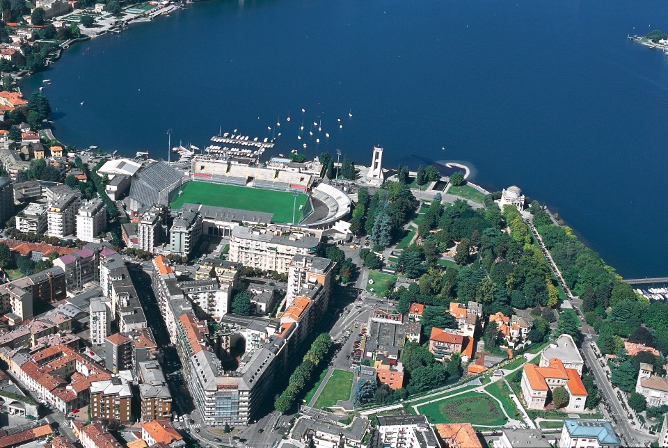 an aerial view of a city with a stadium in the middle