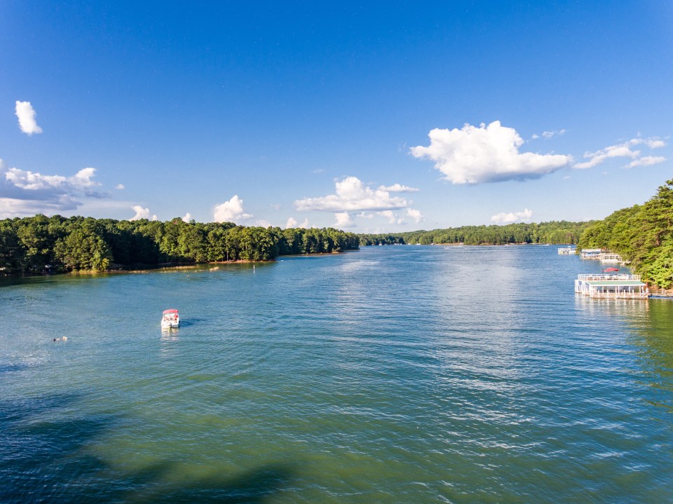 a boat with a red top is floating on a lake