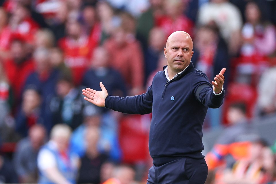 a bald man wearing a blue shirt with a crown on it