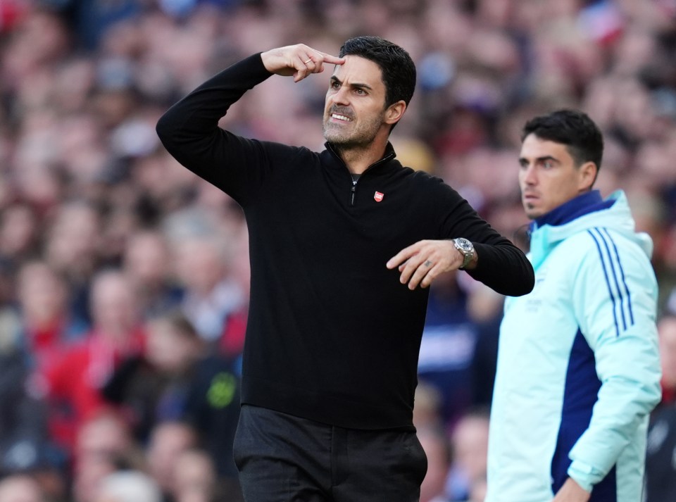 a man in a black sweater with the word arsenal on it