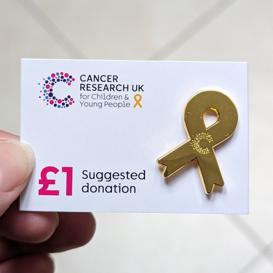 The awareness symbol of Childhood Cancer Awareness Month is available to buy as a badge from Cancer Research UK shops