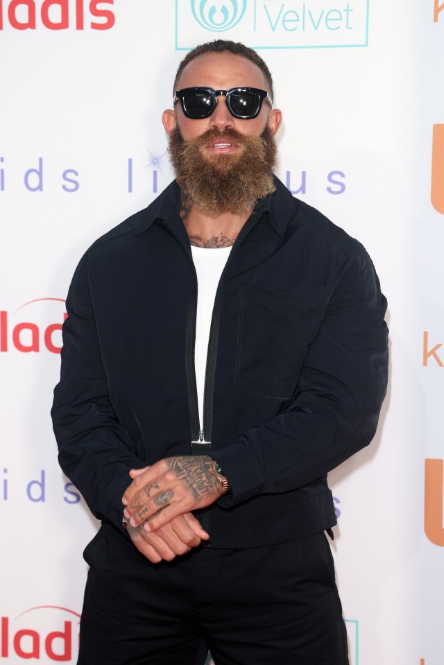 a man with a beard and sunglasses stands in front of a sign that says velvet