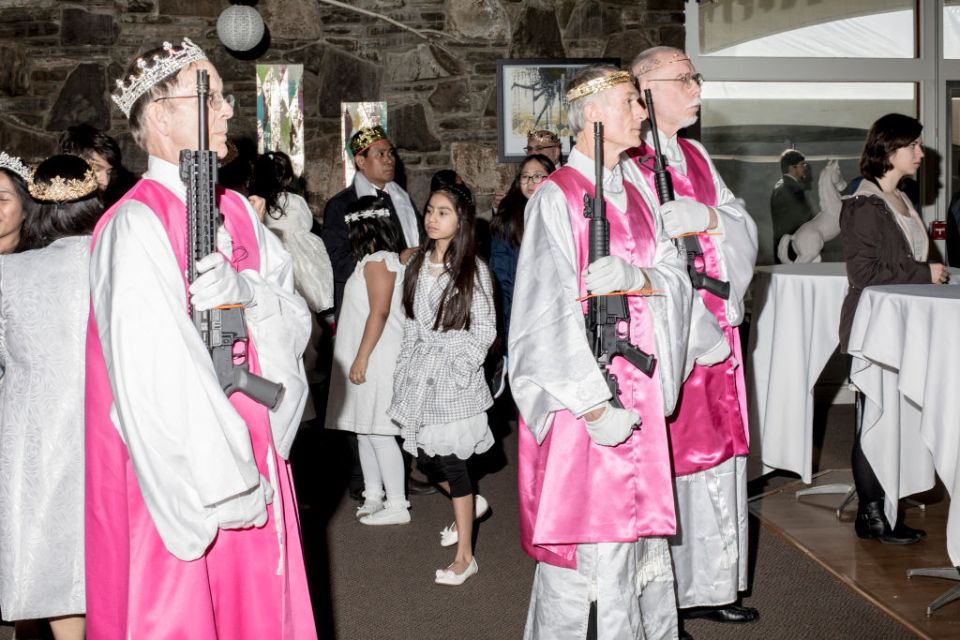 Attendants of the church hold their assault rifles during a sermon in 2018