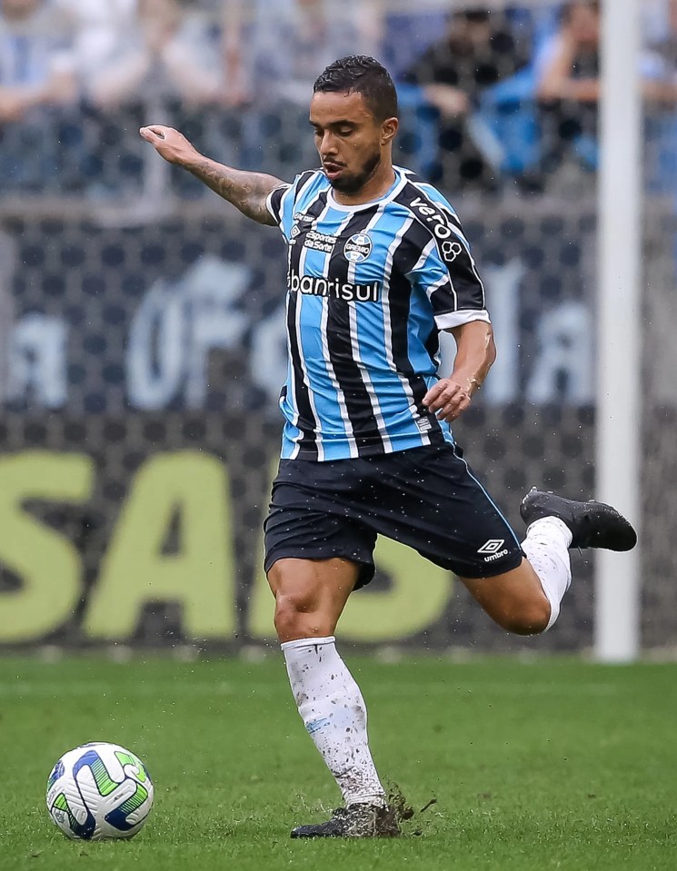 a soccer player kicking a ball with a shirt that says ' kaorisui ' on it