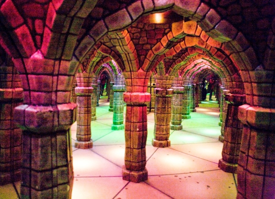 a maze with columns and arches with colored lights