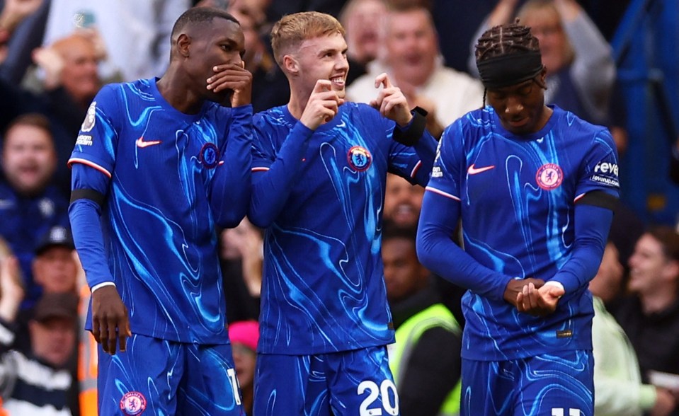 three soccer players wearing blue jerseys with the number 20 on them