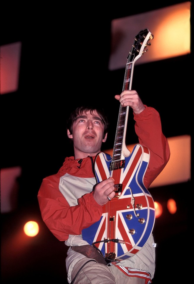 a man playing a guitar with the union jack painted on it