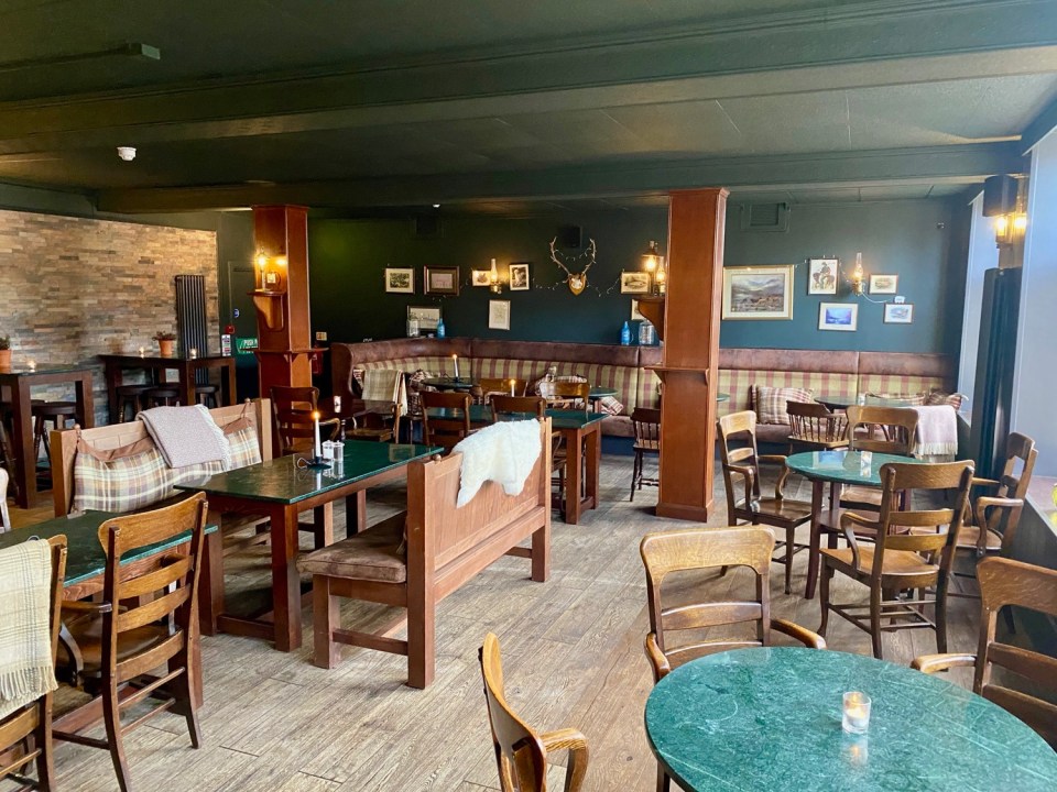 a restaurant with tables and chairs and a green table