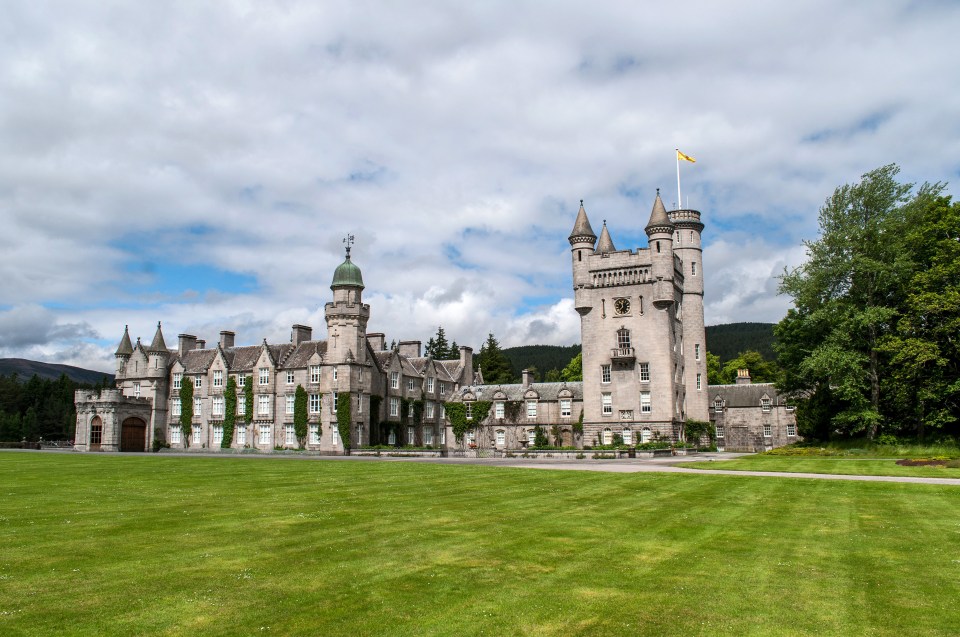 a large castle with a yellow flag on top of it