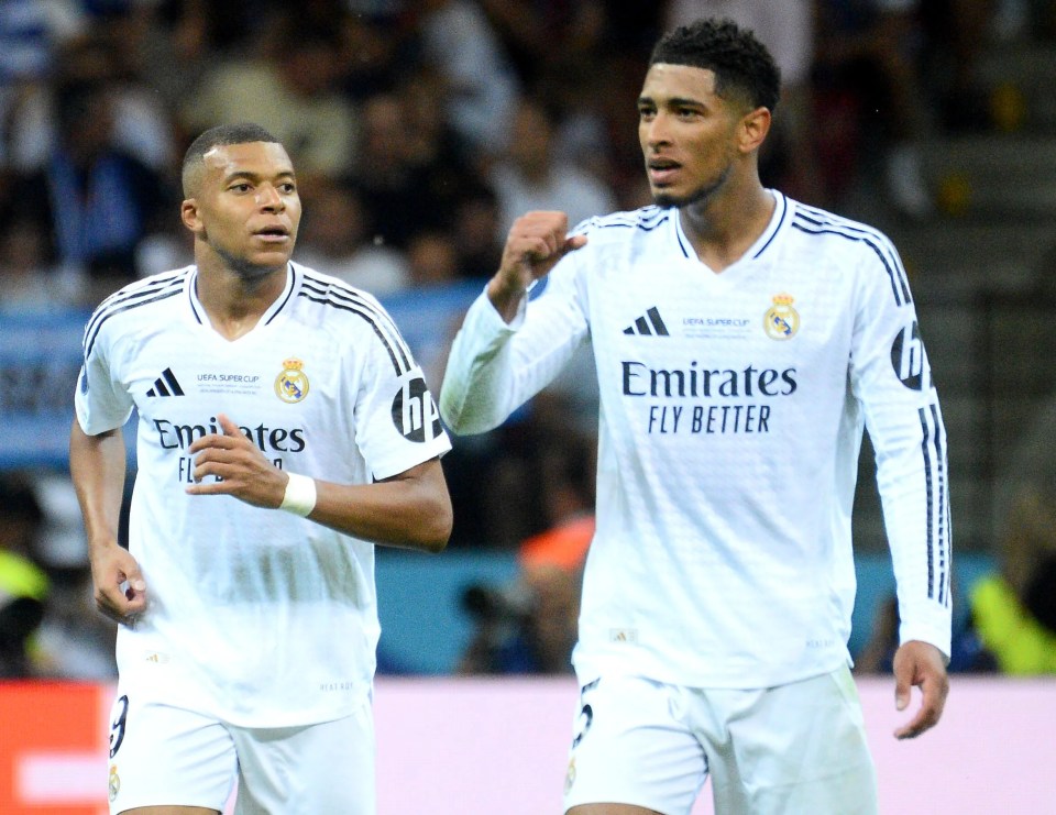 two soccer players with emirates fly better on their shirts