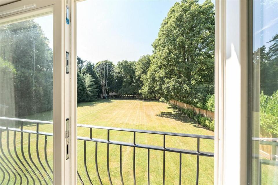 a view of a lush green field from a balcony