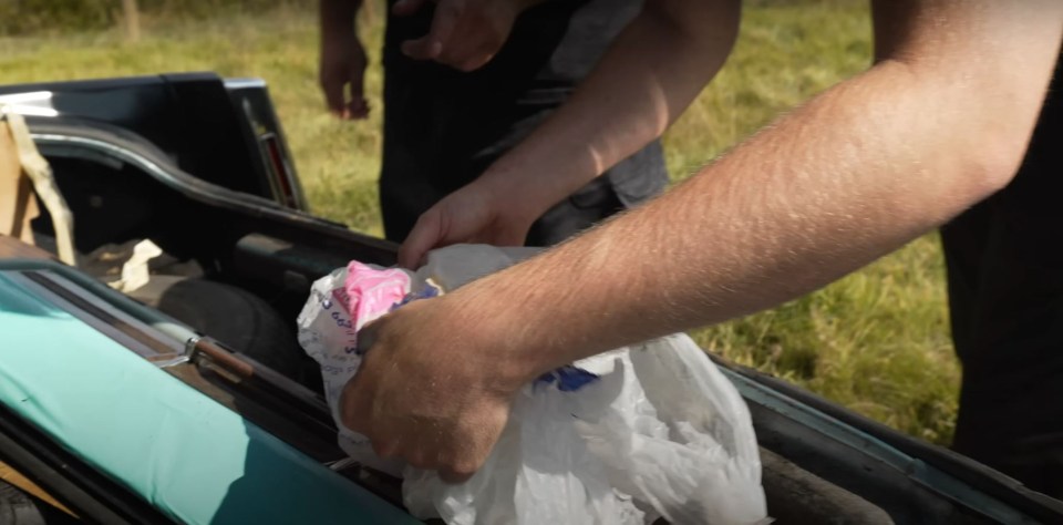 a person is putting something in a plastic bag that says ' ice cream ' on it