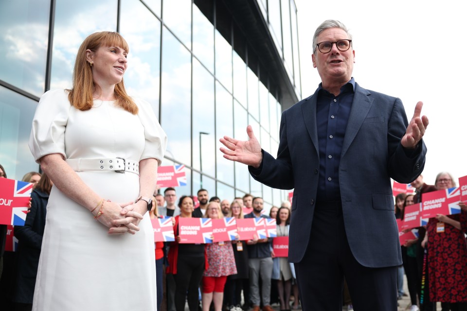 a man and a woman stand in front of a crowd holding signs that say change