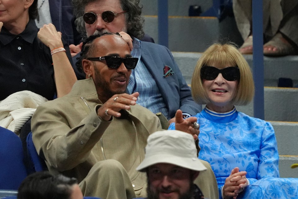 a woman wearing sunglasses sits next to a man wearing sunglasses