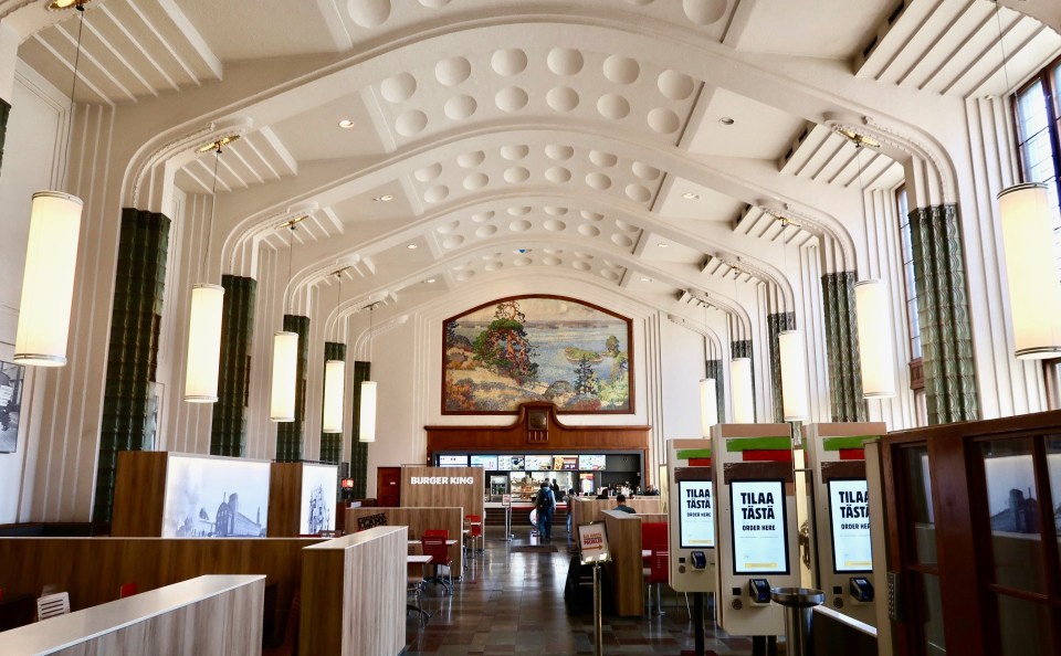 a burger king restaurant with a mural on the wall