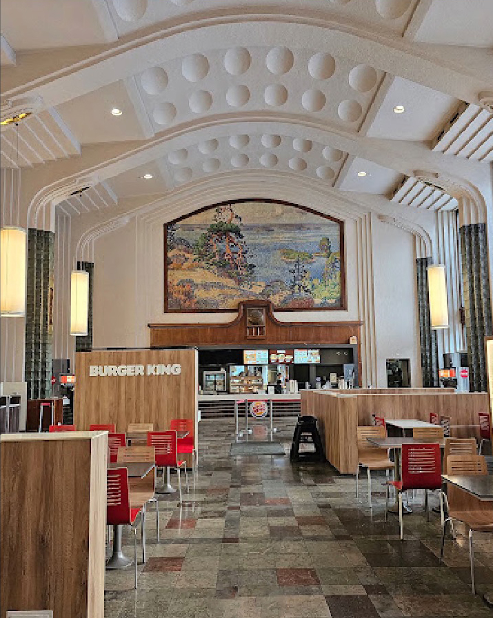 the interior of a burger king restaurant with tables and chairs