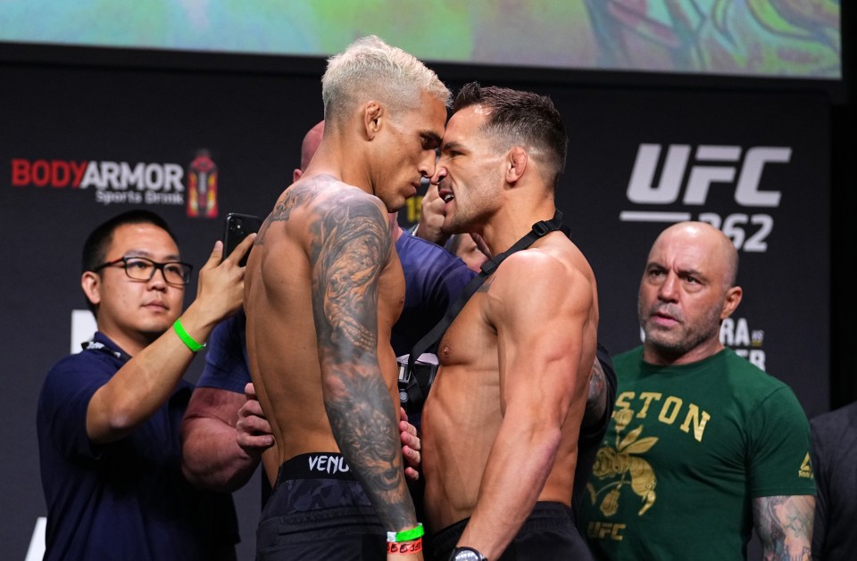 two men standing next to each other in front of a sign that says ufc