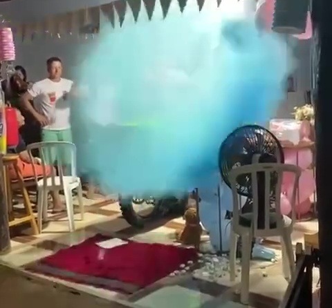 After getting HUGE, the balloon burst into blue smoke, revealing they are expecting a boy