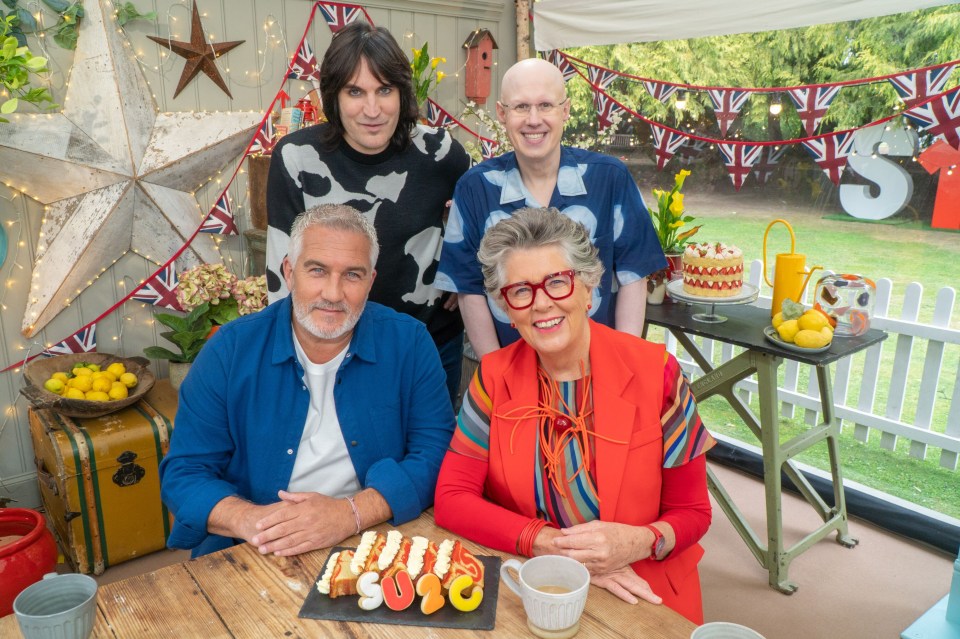 a group of people posing for a picture in front of tents