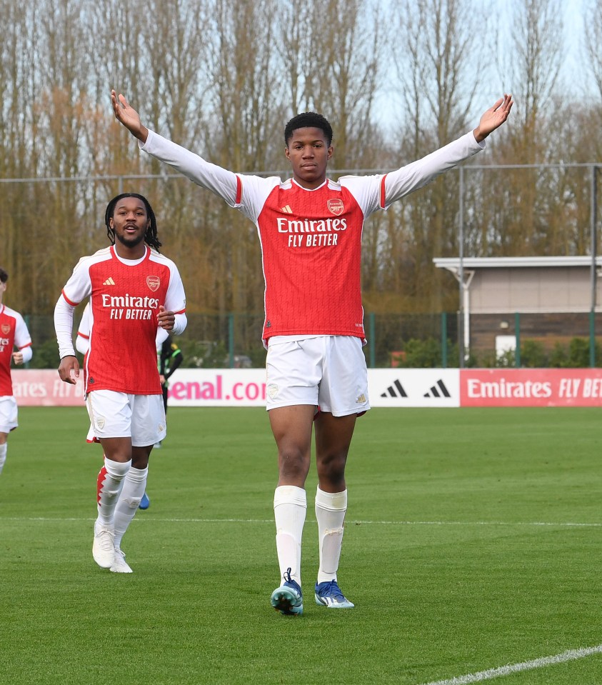 soccer player wearing a red emirates fly better jersey