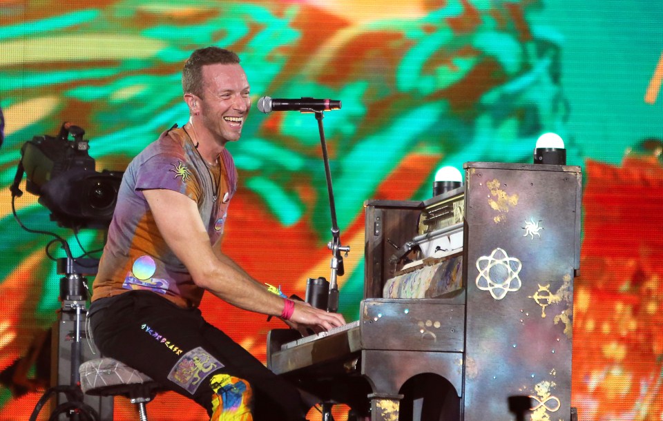 a man playing a piano with the word peace on his pants