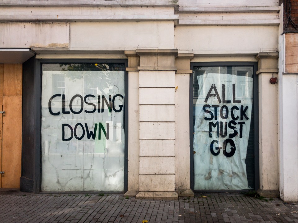 a store front with a sign that says closing down