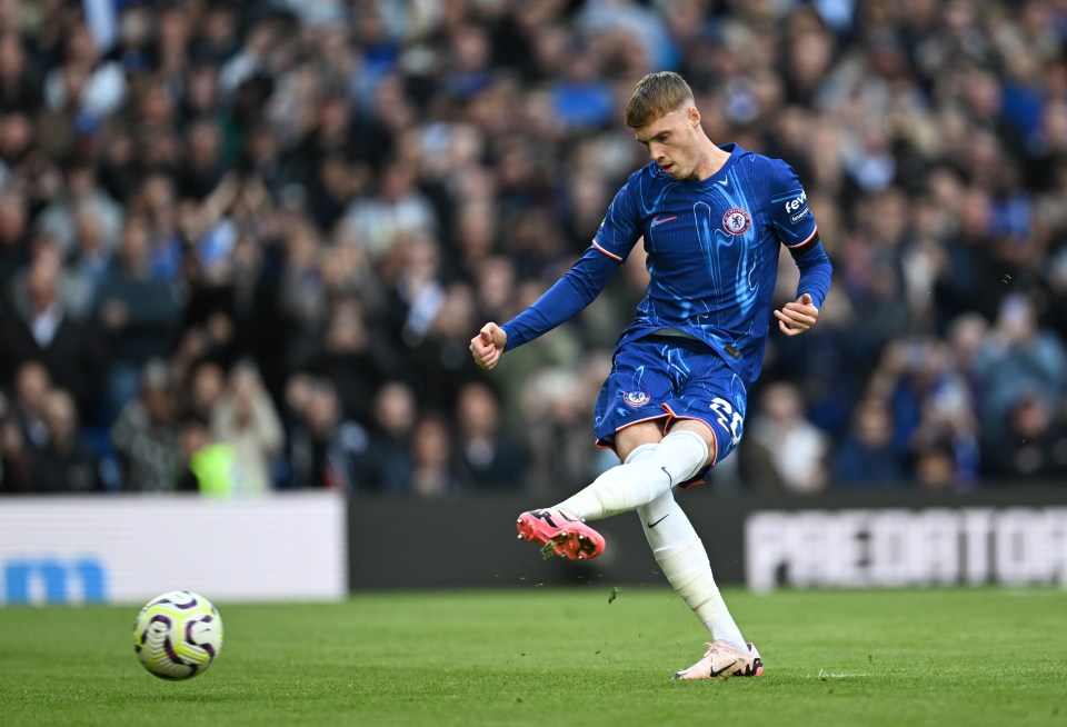 a soccer player kicking a ball with the word predator in the background