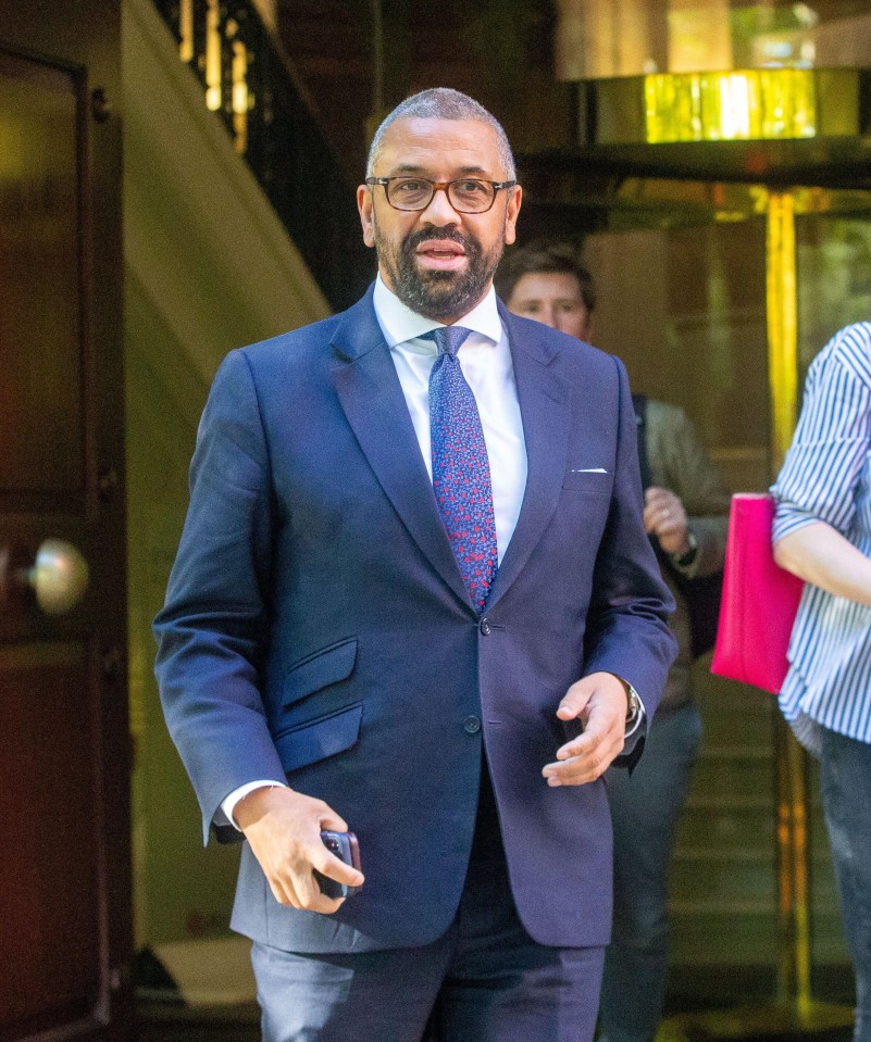 a man in a suit and tie is walking down stairs