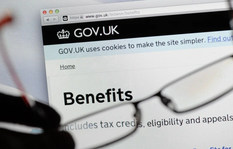 a pair of glasses sits in front of a gov.uk website