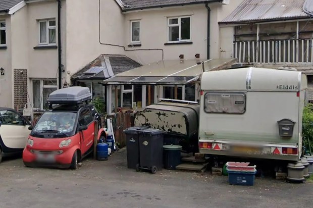 an eddis caravan is parked in front of a house