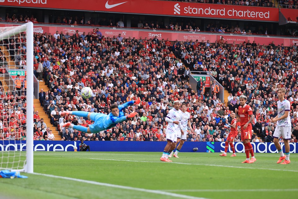 a soccer game is being played in a stadium with a standard chartered banner