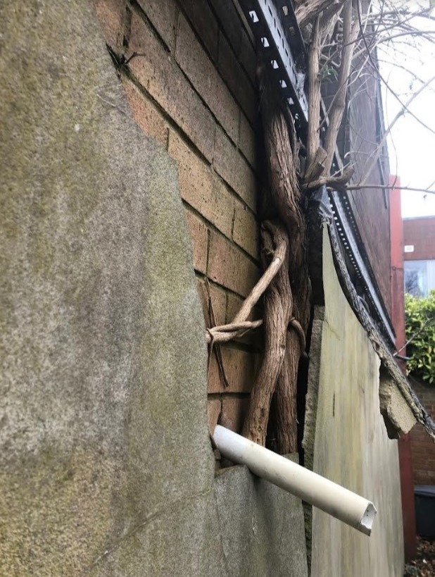 a brick wall with a pipe sticking out of it