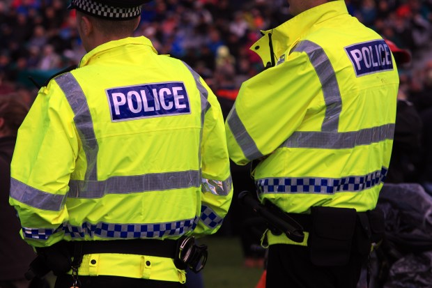 two police officers are standing next to each other