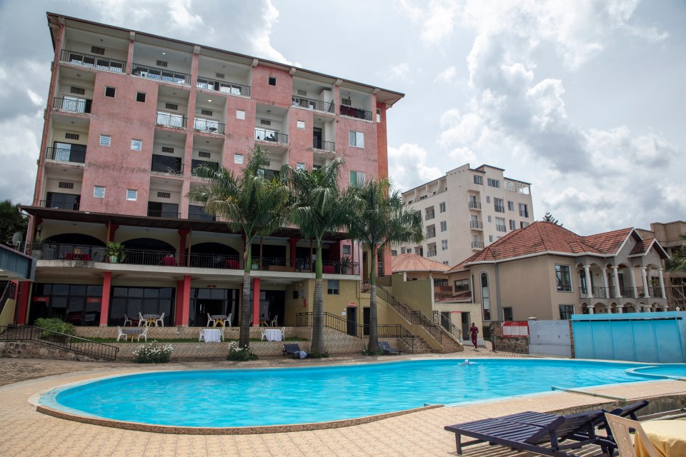 a large building with a swimming pool in front of it