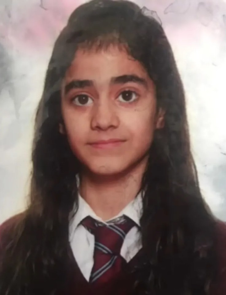 a young girl wearing a school uniform and tie