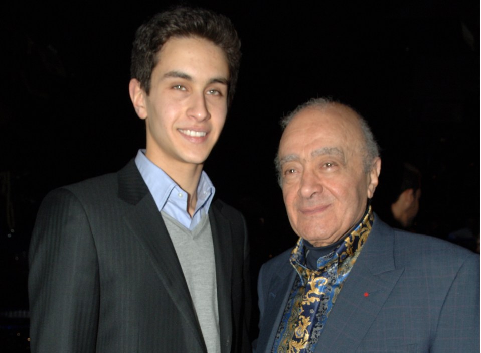 a man in a suit stands next to a younger man