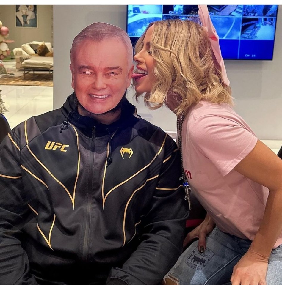 a woman sticking her tongue out next to a man wearing a ufc jacket